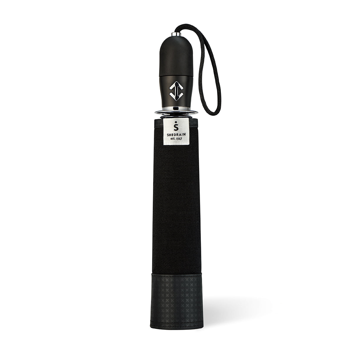straight on view of a handmade manual open compact luxury umbrella with a matte black TPR grip handle containing a chrome double arrow button, detachable waxed cotton wrist strap, Teflon-coated fine denier woven black polyester twill canopy, chrome trim, Trilobe aircraft aluminum shaft, fiberglass ribs, and a reflective strap embroidered with “ShedRain Stratus" in its free-standing canvas case.