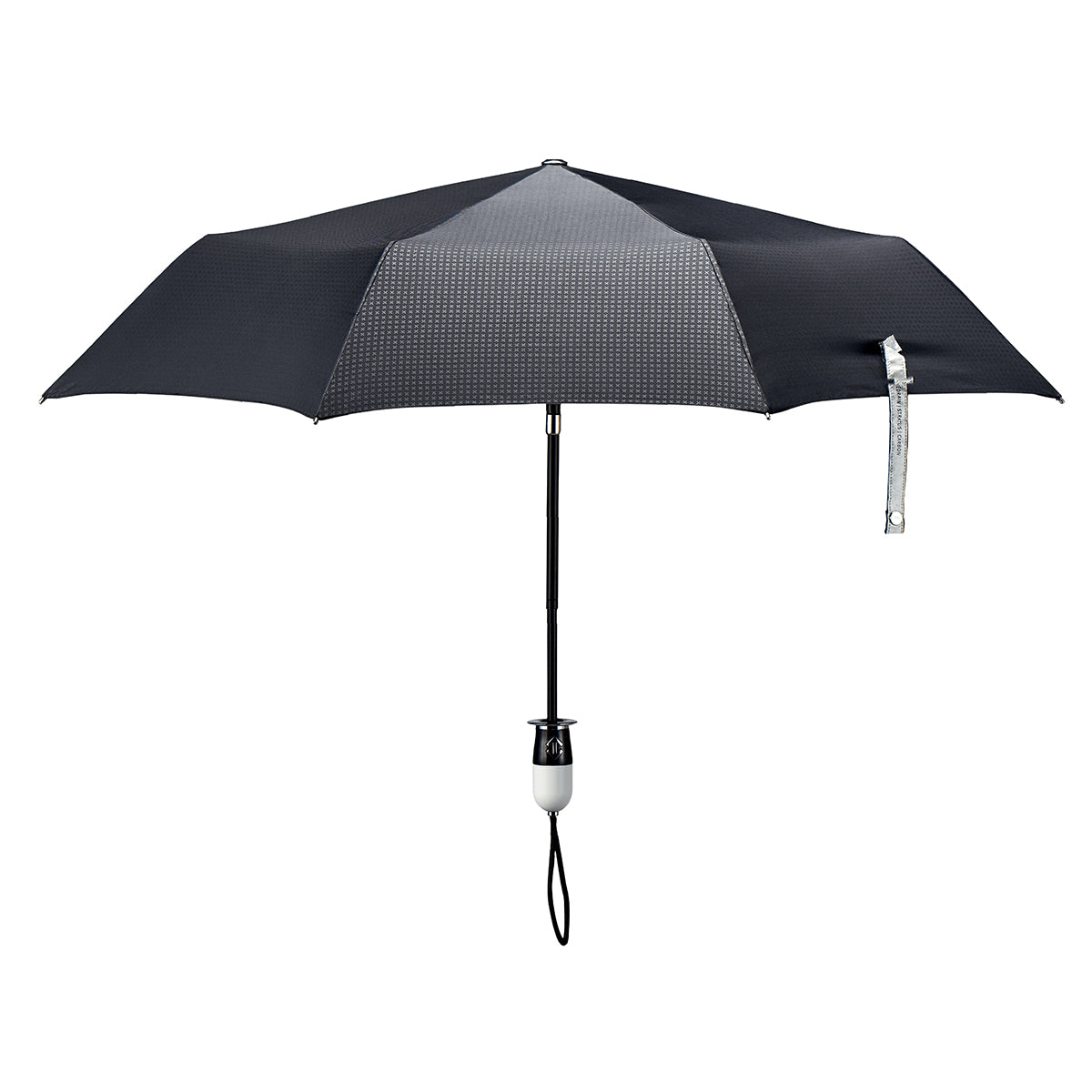 straight on view of a handmade auto open auto close open compact luxury umbrella with a glossy piano finish black and white handle containing a chrome double arrow button, detachable waxed cotton wrist strap, Teflon-coated fine denier woven black polyester twill canopy, chrome trim, Trilobe aircraft aluminum shaft, fiberglass ribs, and a reflective strap embroidered with “ShedRain Stratus.”