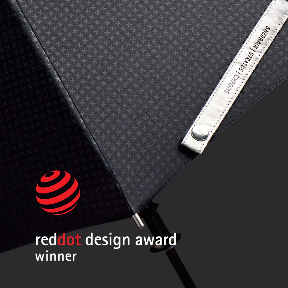 woman holding black Stratus umbrella in rain on a black background