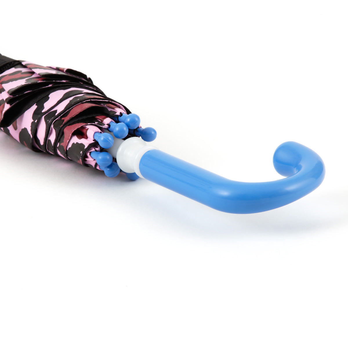 close up of the handle of a brightly colored childrens umbrella in a black and pink cat design with big blue eyes, whiskers, pink leopard print trim and pop-up kitty ears on top. matching bright blue curved crook handle.