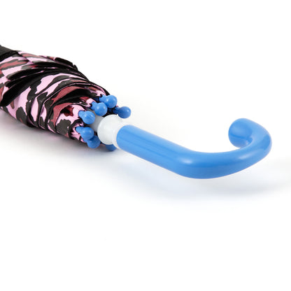 close up of the handle of a brightly colored childrens umbrella in a black and pink cat design with big blue eyes, whiskers, pink leopard print trim and pop-up kitty ears on top. matching bright blue curved crook handle.