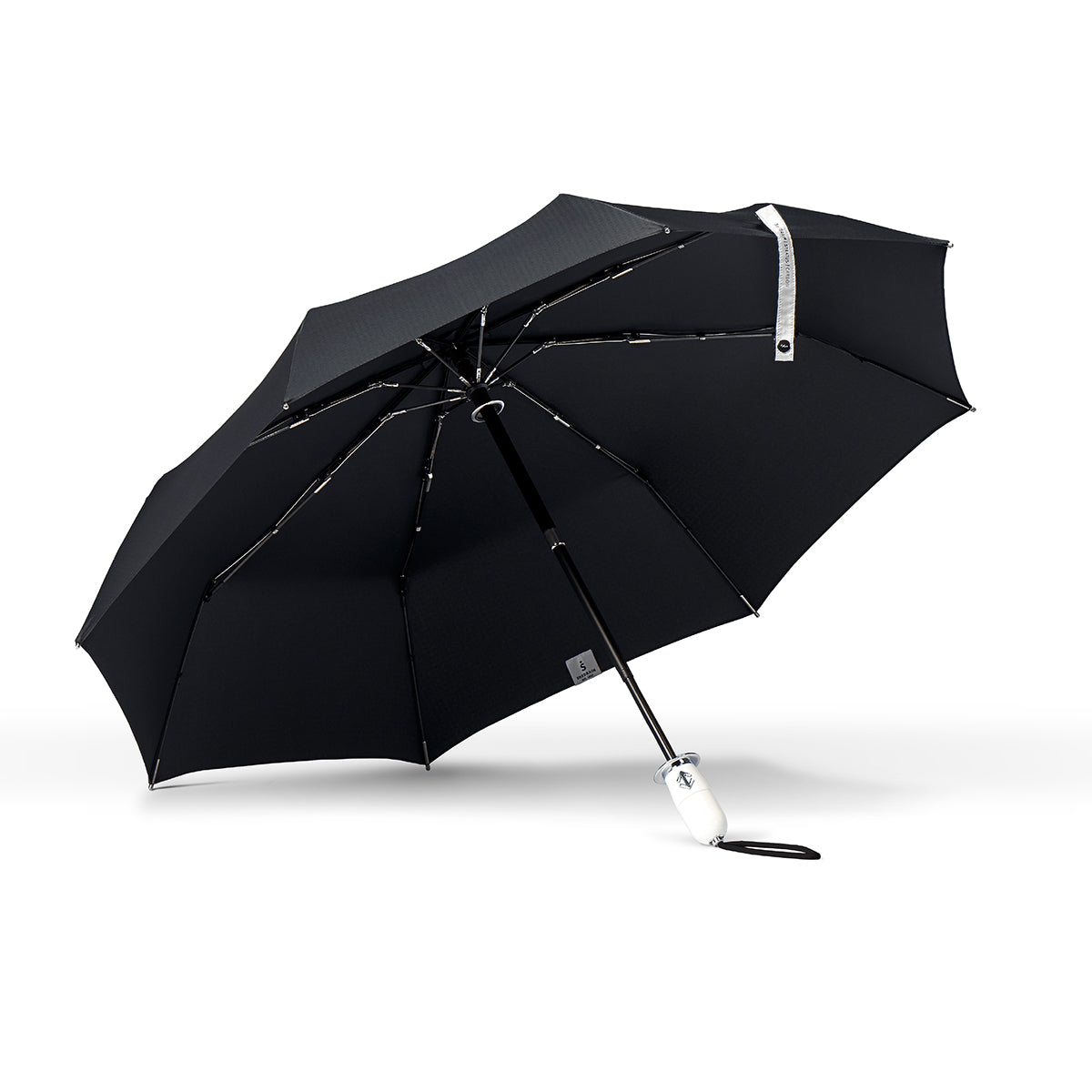 Underside view of a high end compact black umbrella with chrome details and a shiny white handle