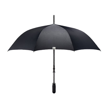 straight on view of a handmade manual open luxury golf umbrella with a matte black TPR grip handle, Teflon-coated fine denier woven black polyester twill canopy, chrome trim, carbon fiber shaft, fiberglass ribs, and a reflective strap embroidered with “ShedRain Stratus.”